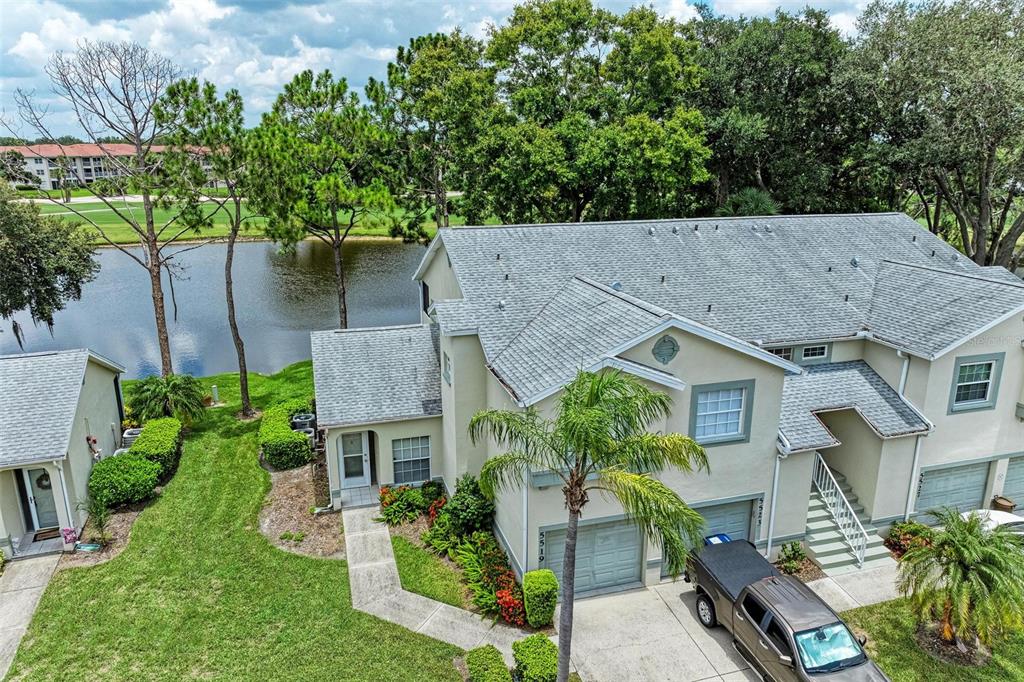 an aerial view of a house with a yard and potted plants