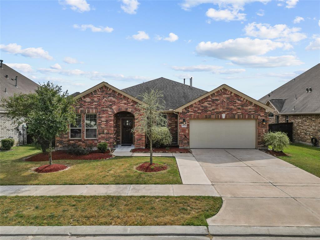 a front view of a house with a yard and garage