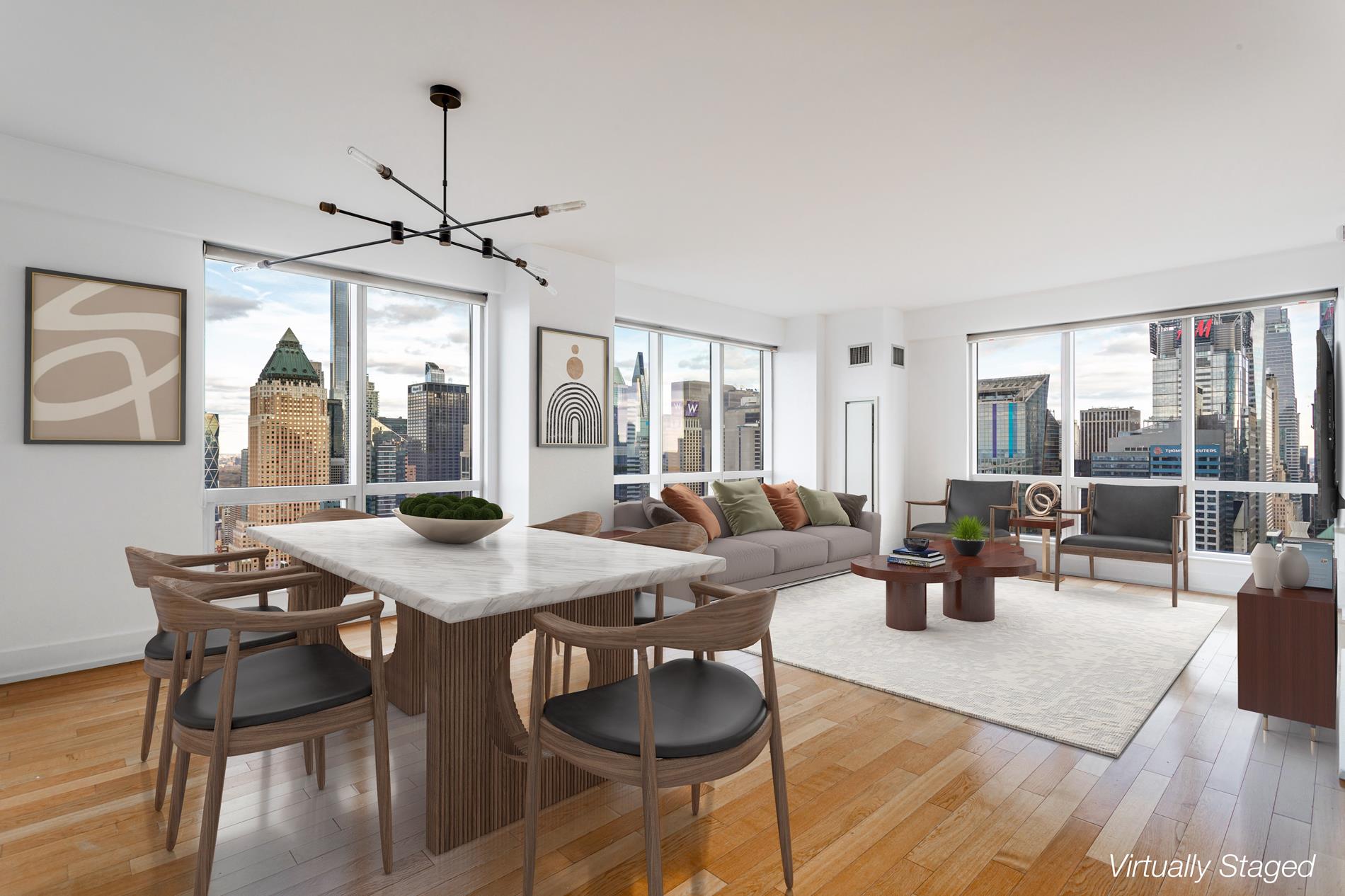 a view of a dining room and livingroom with furniture wooden floor a chandelier