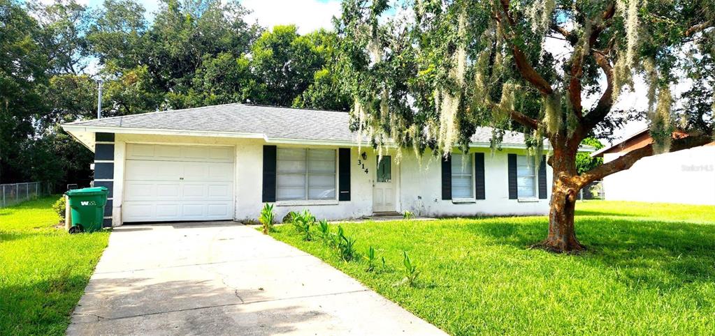 a front view of house with yard and green space