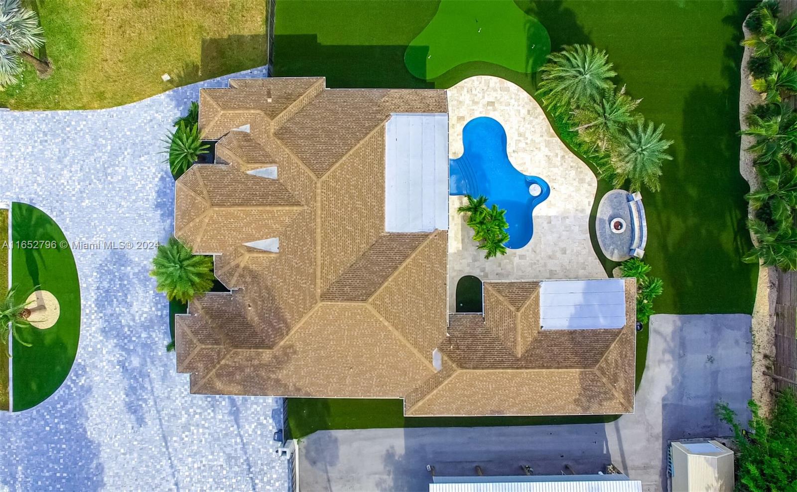 an aerial view of a house with a swimming pool