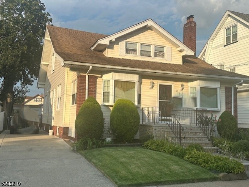 a view of a brick house with large windows