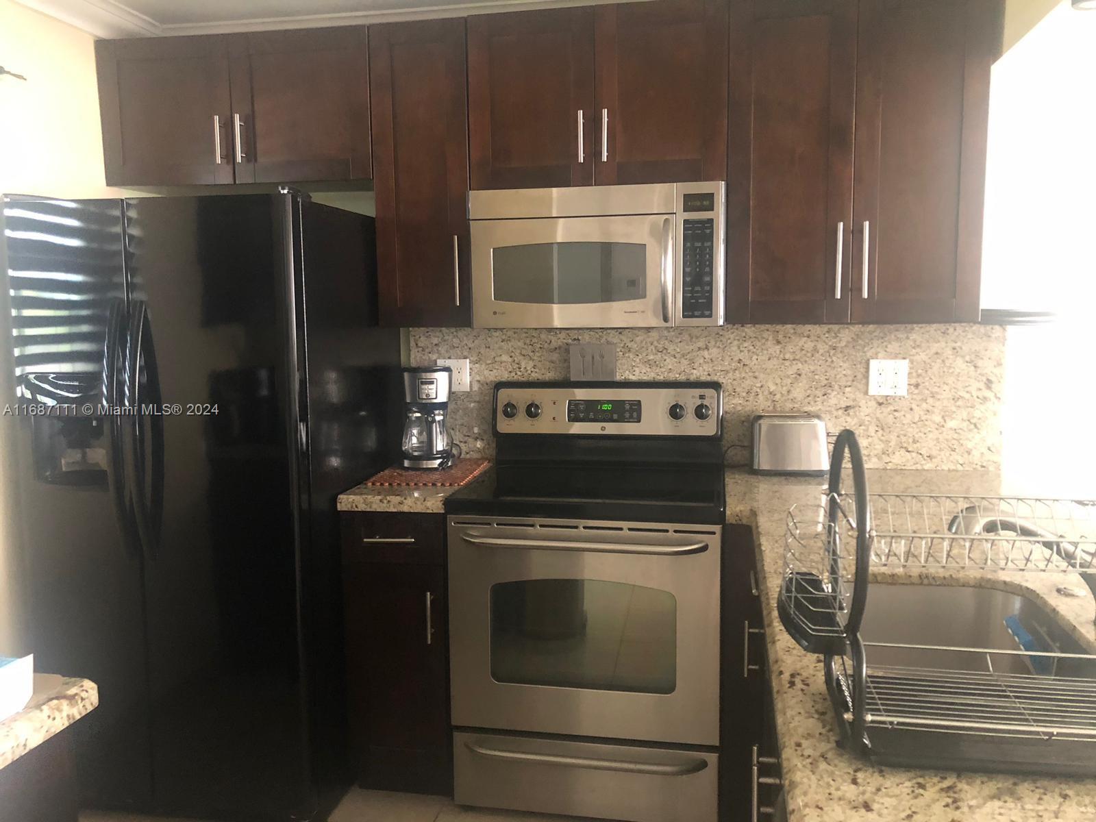 a kitchen with a stove and a microwave