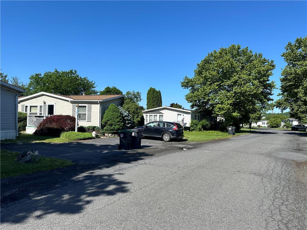 a car parked in front of a house with a yard