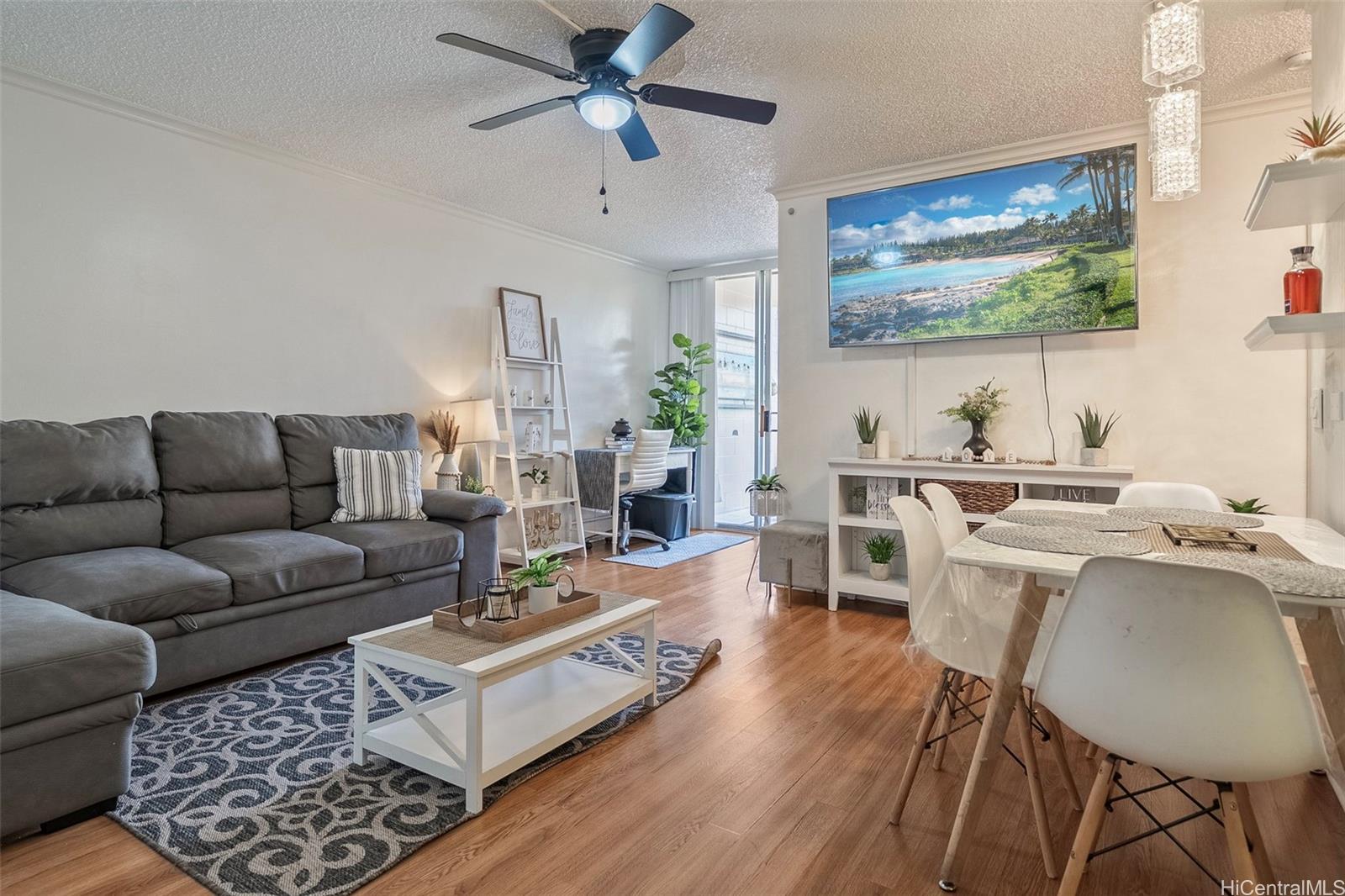 a living room with furniture and a wooden floor