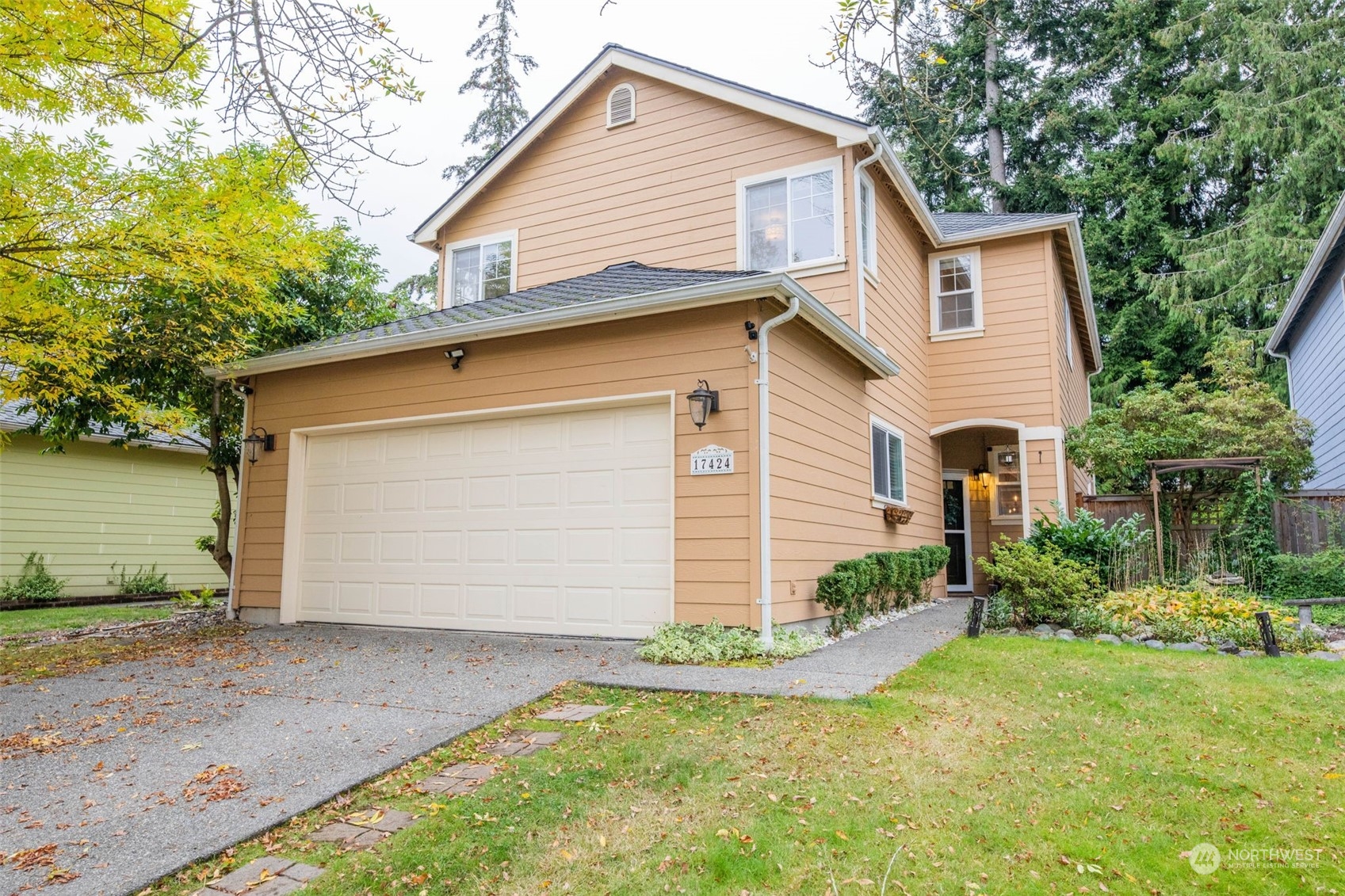 a view of backyard of house and garage