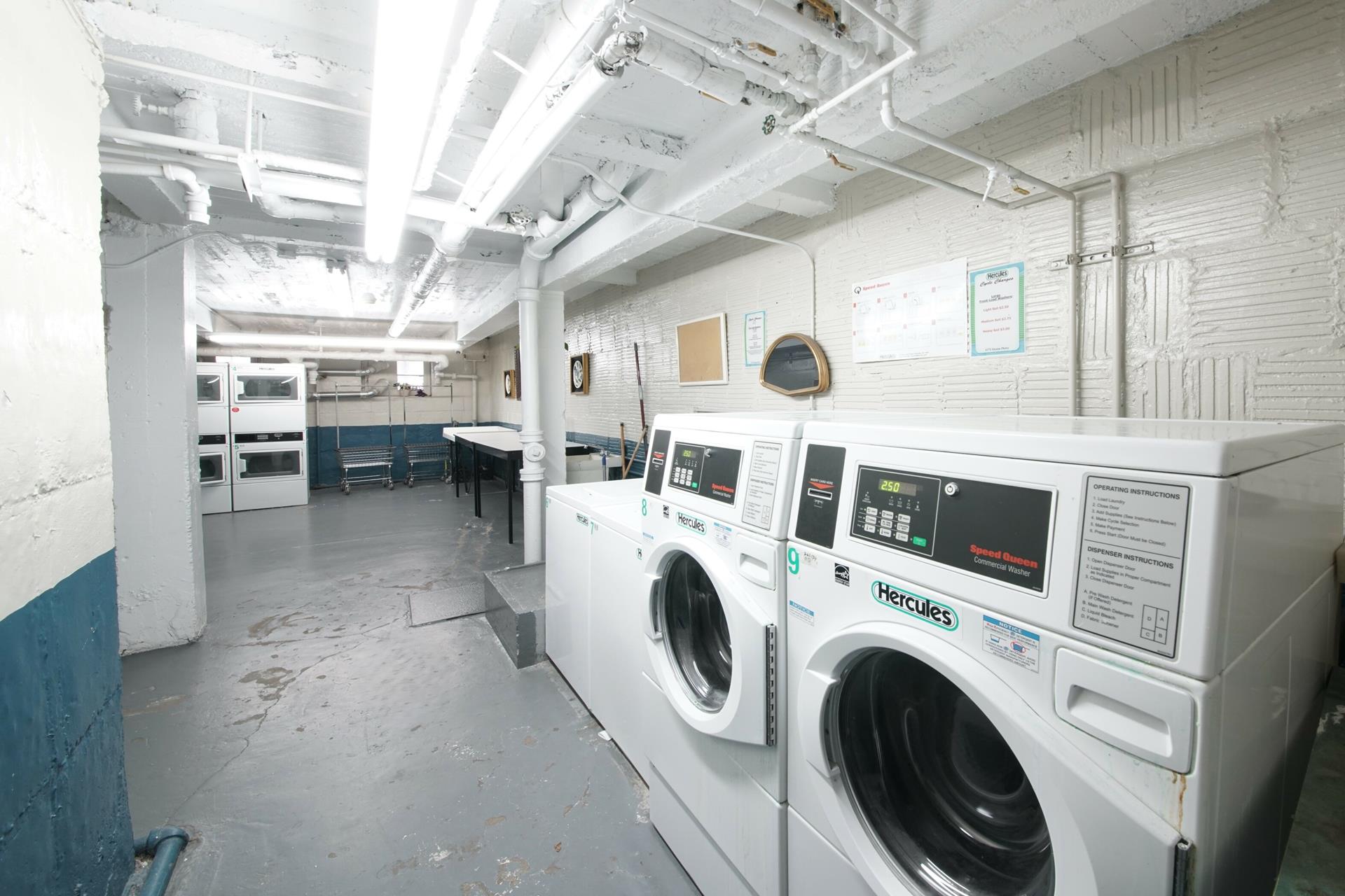 a view of washer and dryer with kitchen in the background