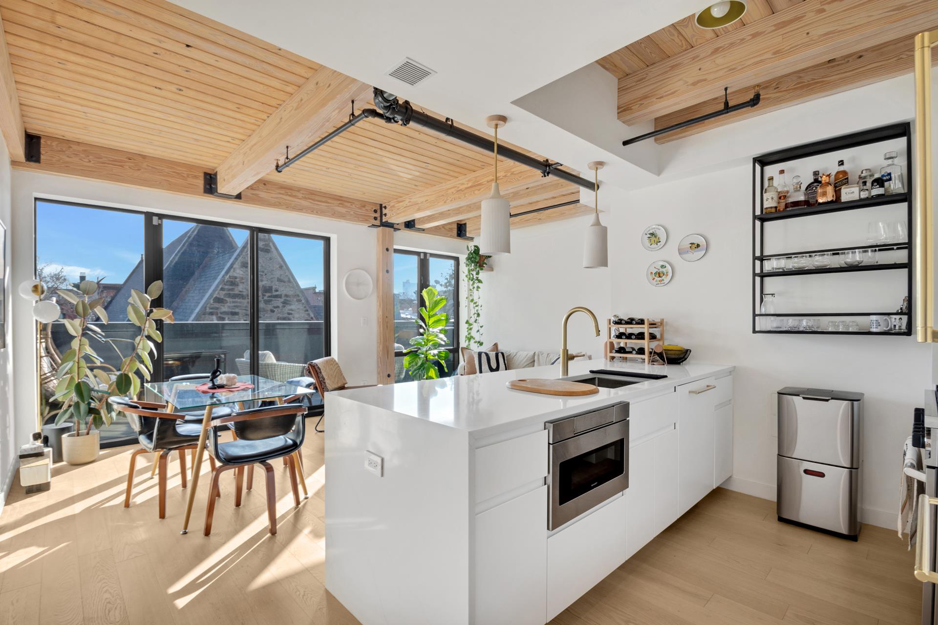 a kitchen with a stove a sink and a dining table