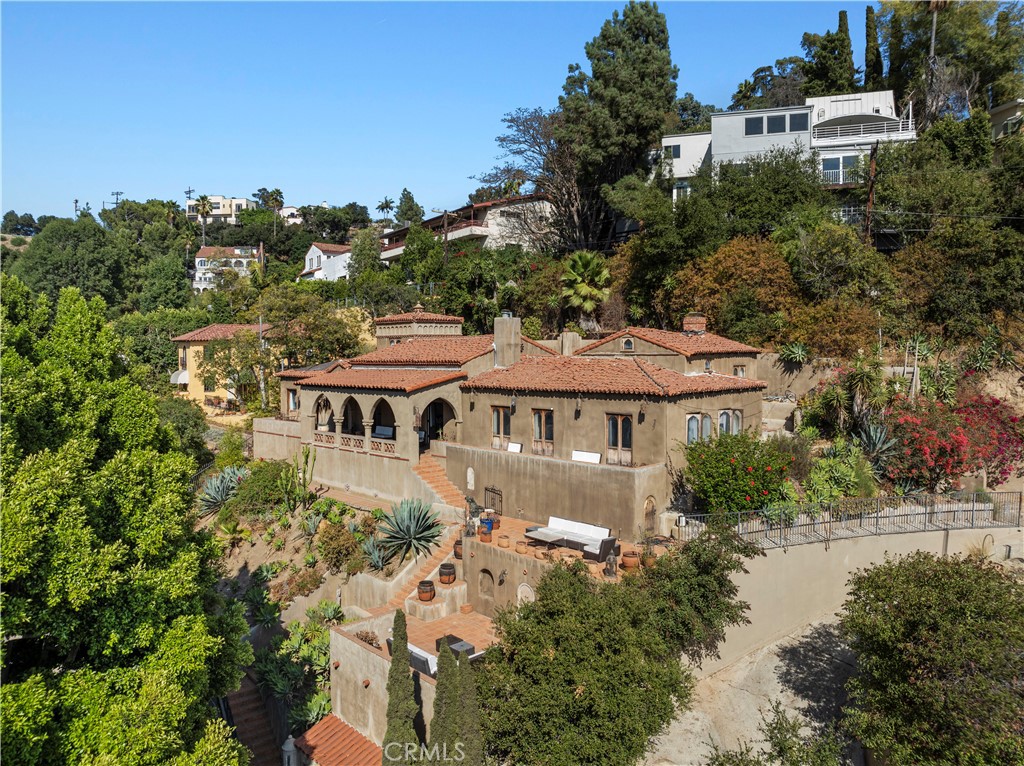 an aerial view of a house with a yard and lake view