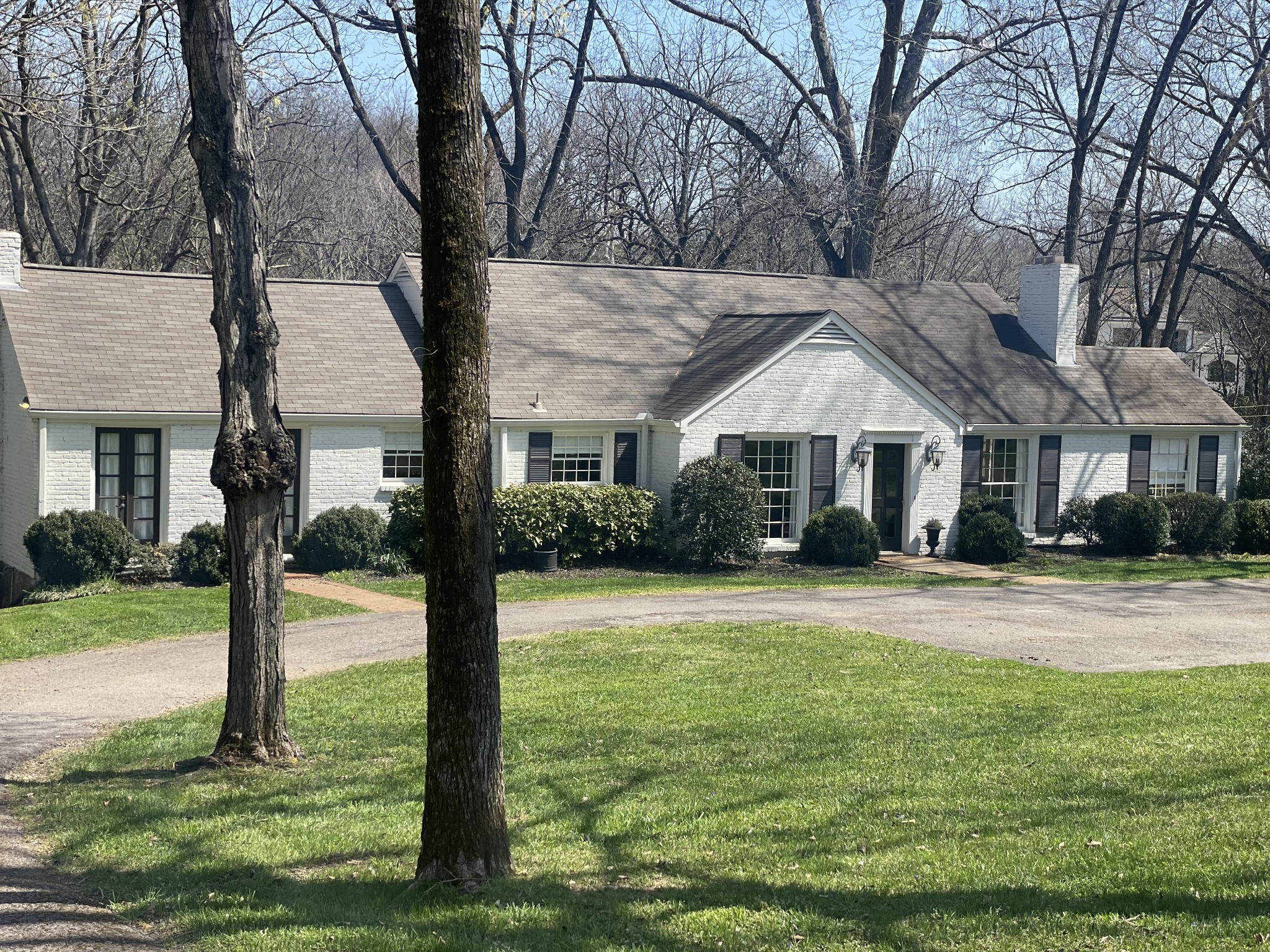 a front view of house with yard and green space