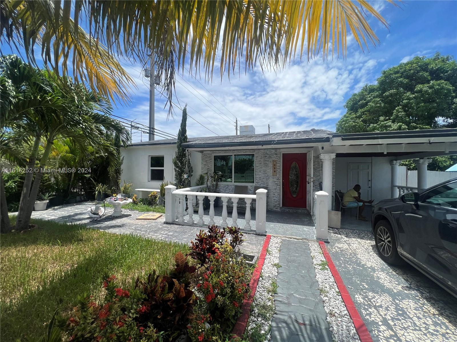 a view of house with backyard and outdoor seating