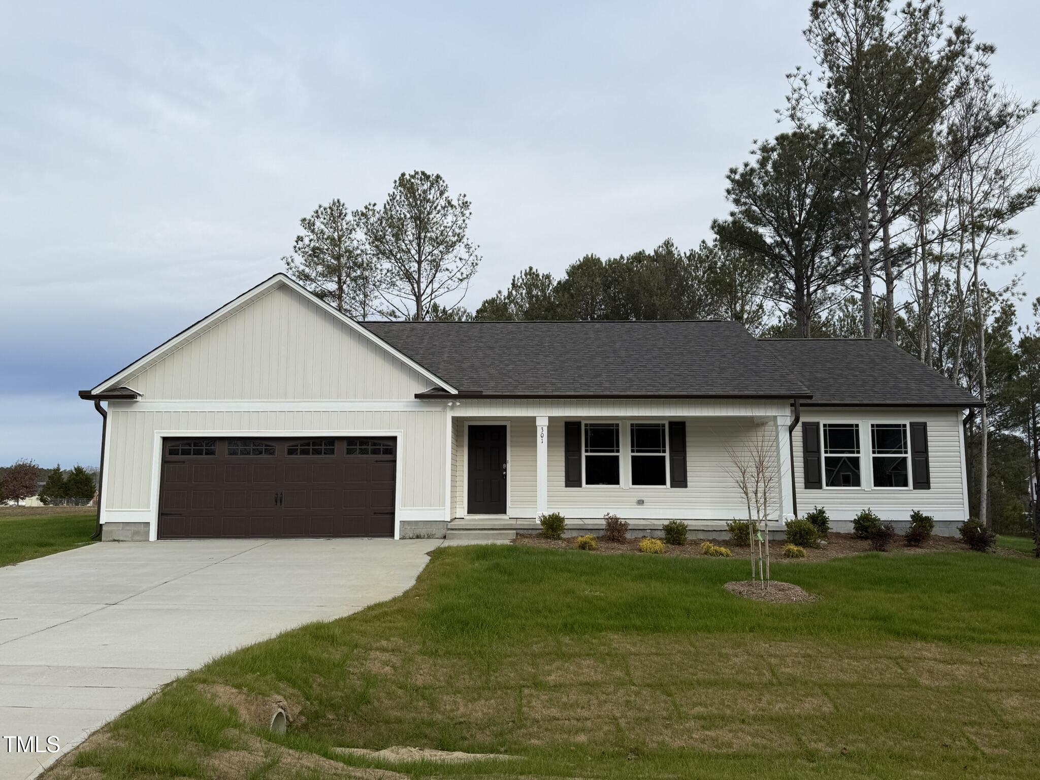 a front view of house with yard and green space