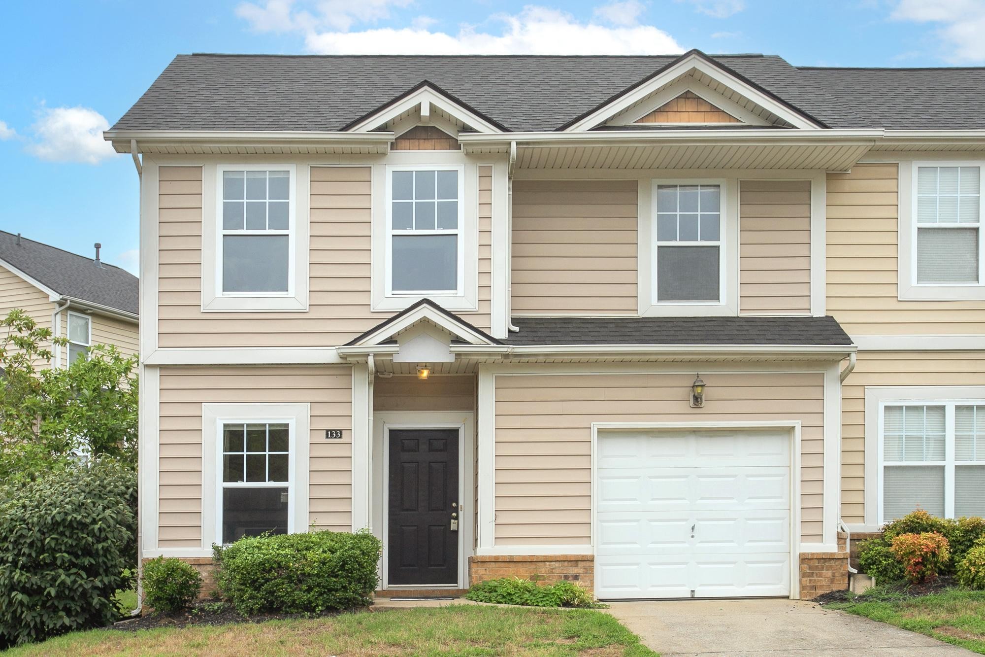 a front view of a house with a yard