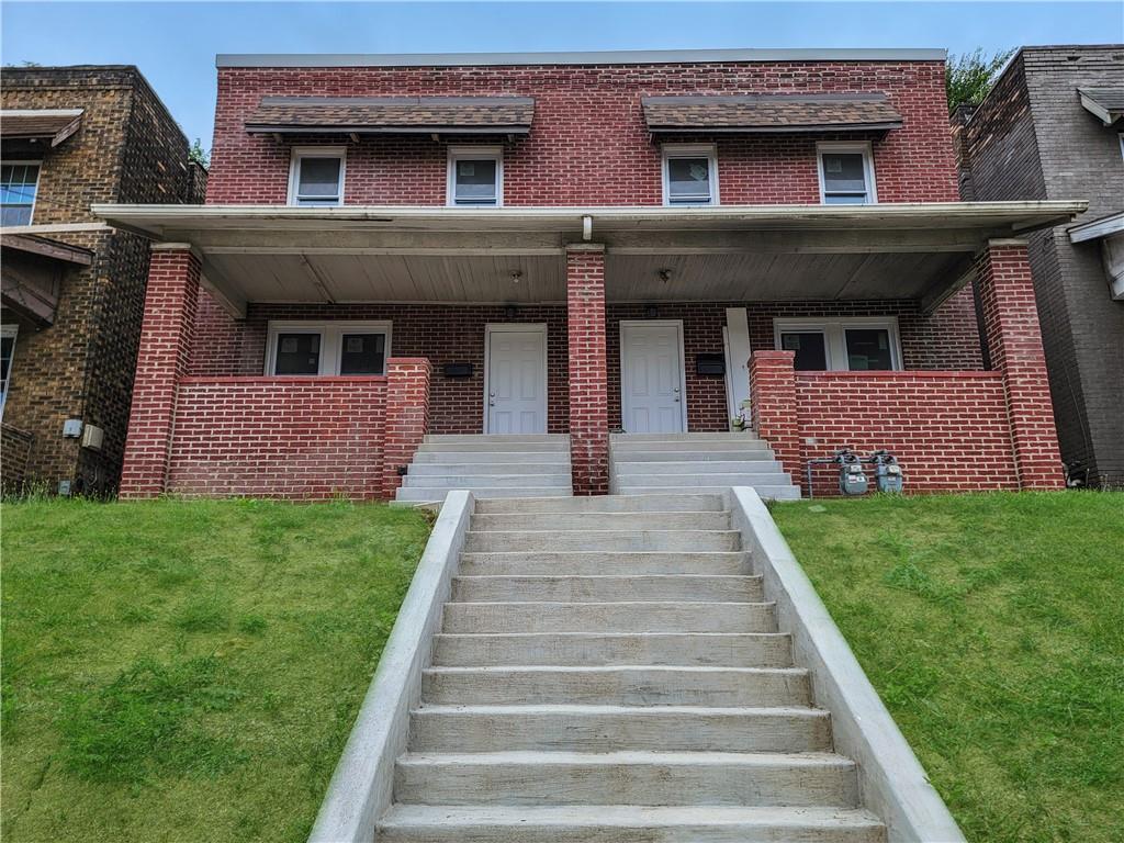 a front view of a house with a yard