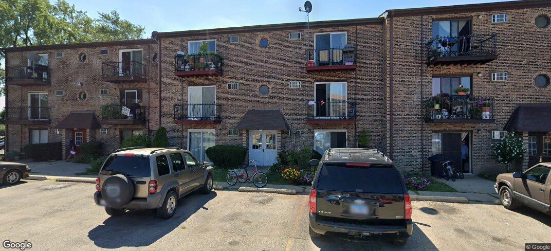 a car parked in front of a brick building