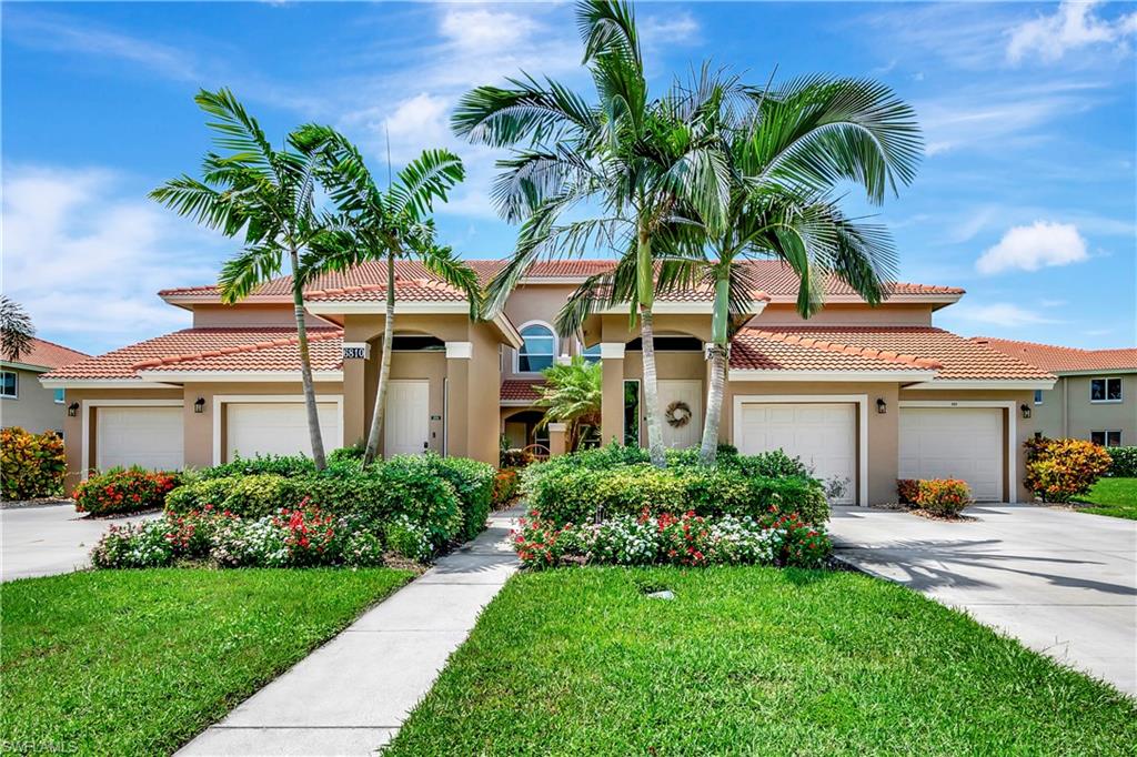 Mediterranean / spanish-style home featuring a front lawn and a garage