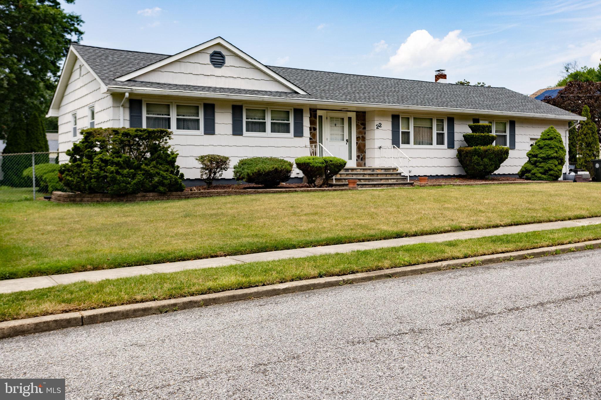 a front view of a house with a garden and yard