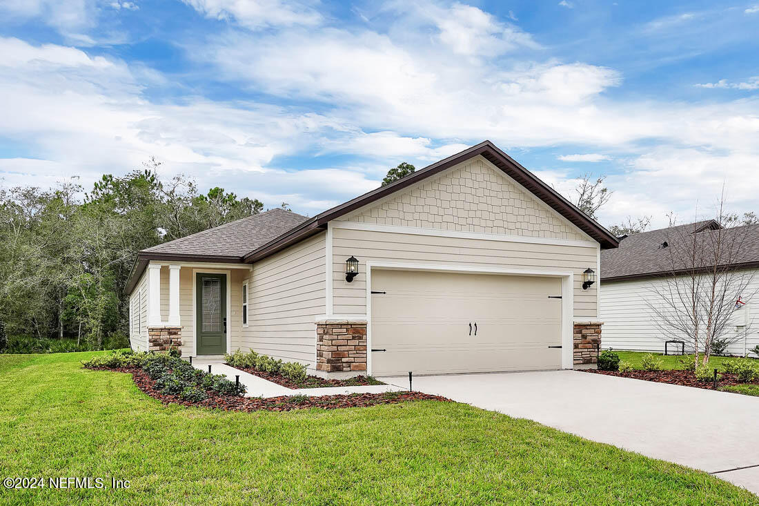 a front view of house with yard and green space