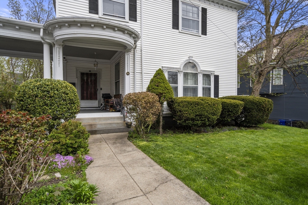 a front view of a house with a garden