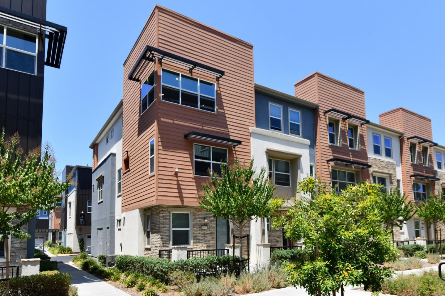 a front view of a residential apartment building with a yard