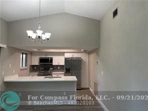 a view of kitchen with microwave and cabinets