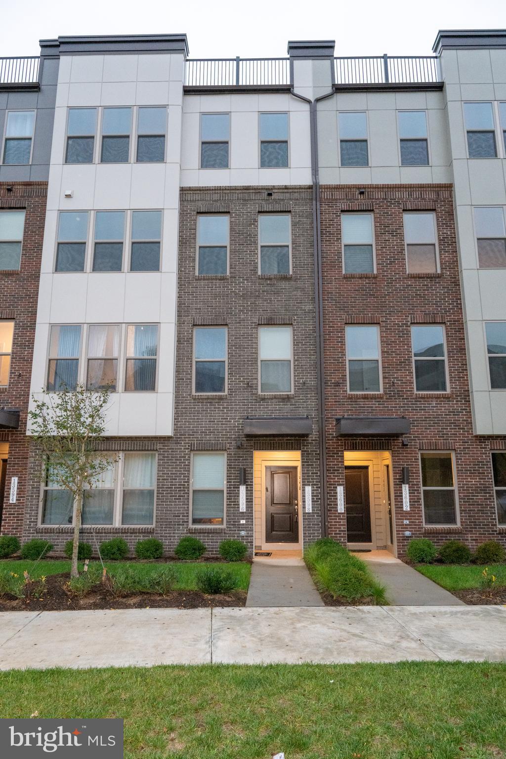 a view of a brick building next to a yard