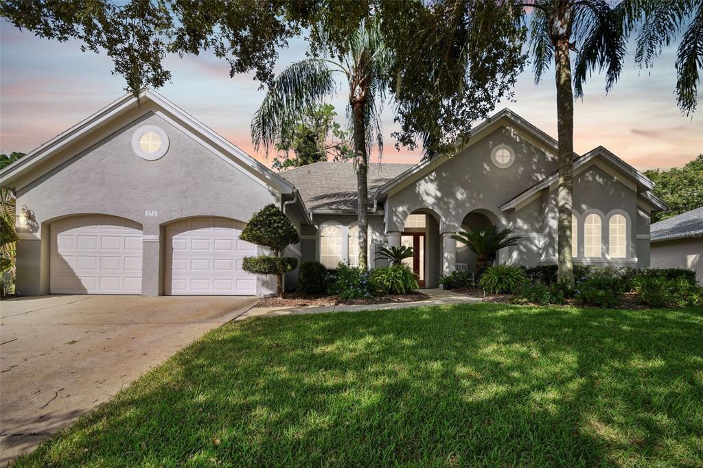 a front view of a house with a yard and garage