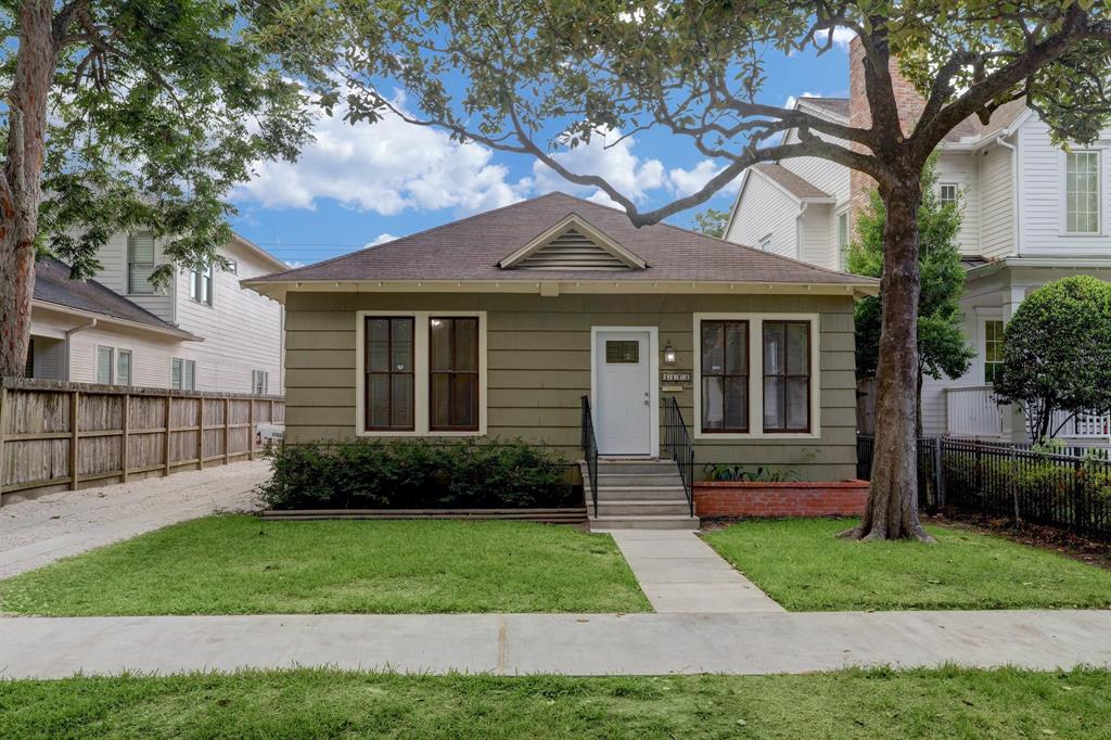 a front view of a house with a yard and plants