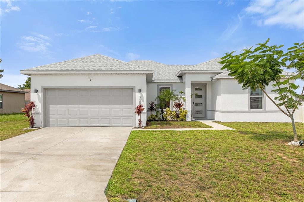 a front view of a house with a yard and garage