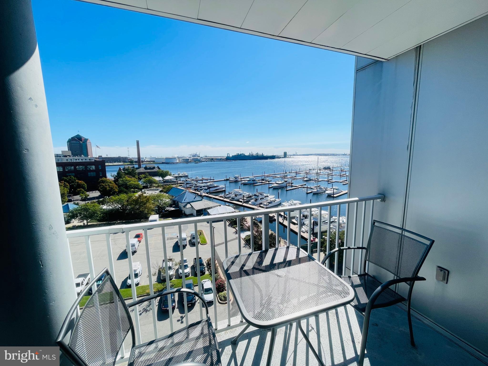 a balcony with wooden floor outdoor seating and city view