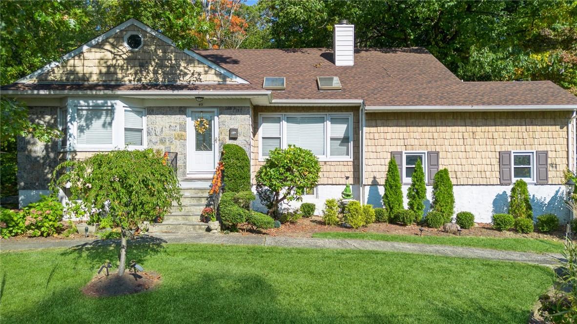 a front view of a house with a yard and glass windows