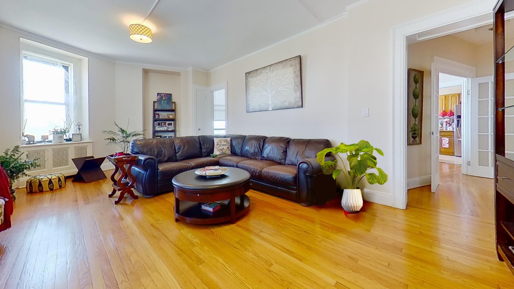 a living room with furniture and a wooden floor