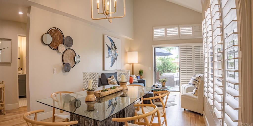 a living room with furniture a chandelier and a window