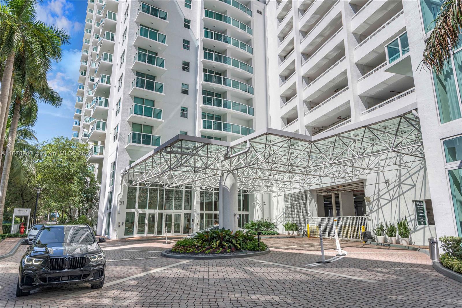 front view of a building with a cars parked