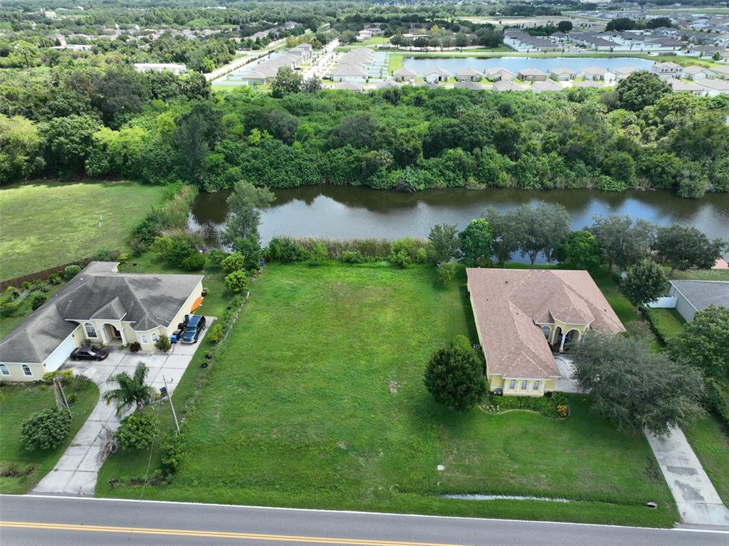 an aerial view of a house with yard