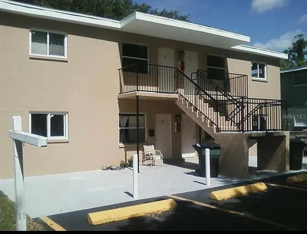 a view of roof deck with chair and tables