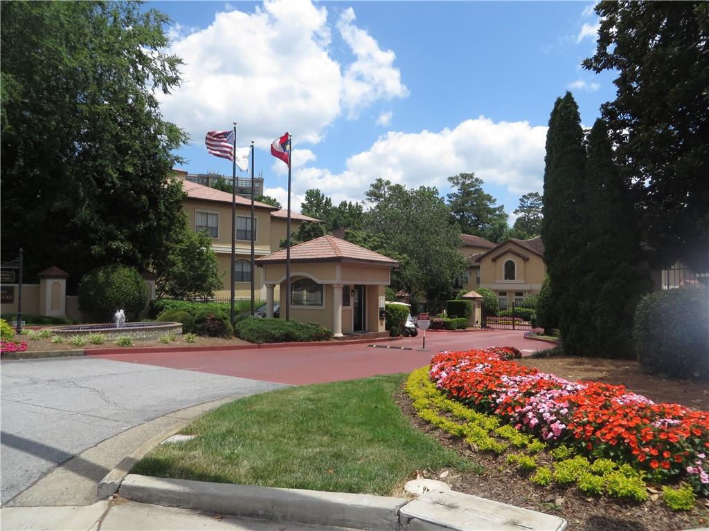 a front view of a house with a yard and fountain