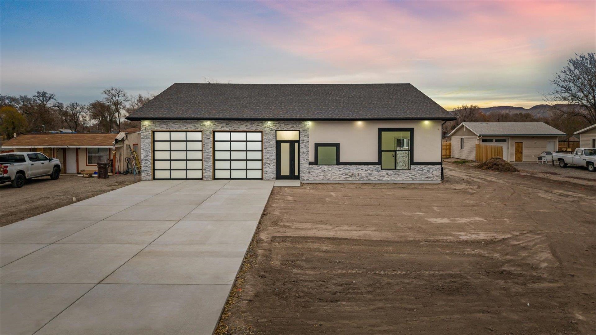 a front view of a house with a yard and garage