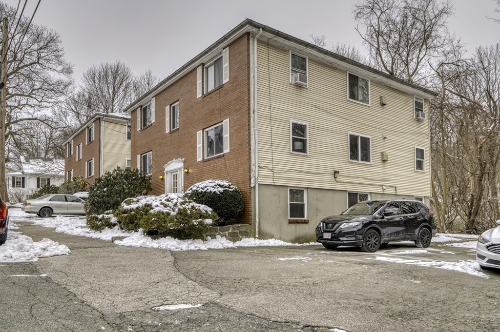 a view of a car park in front of a house