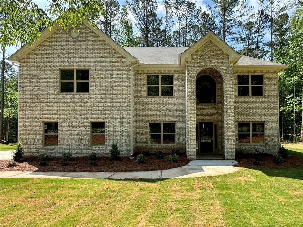 a front view of a house with a yard