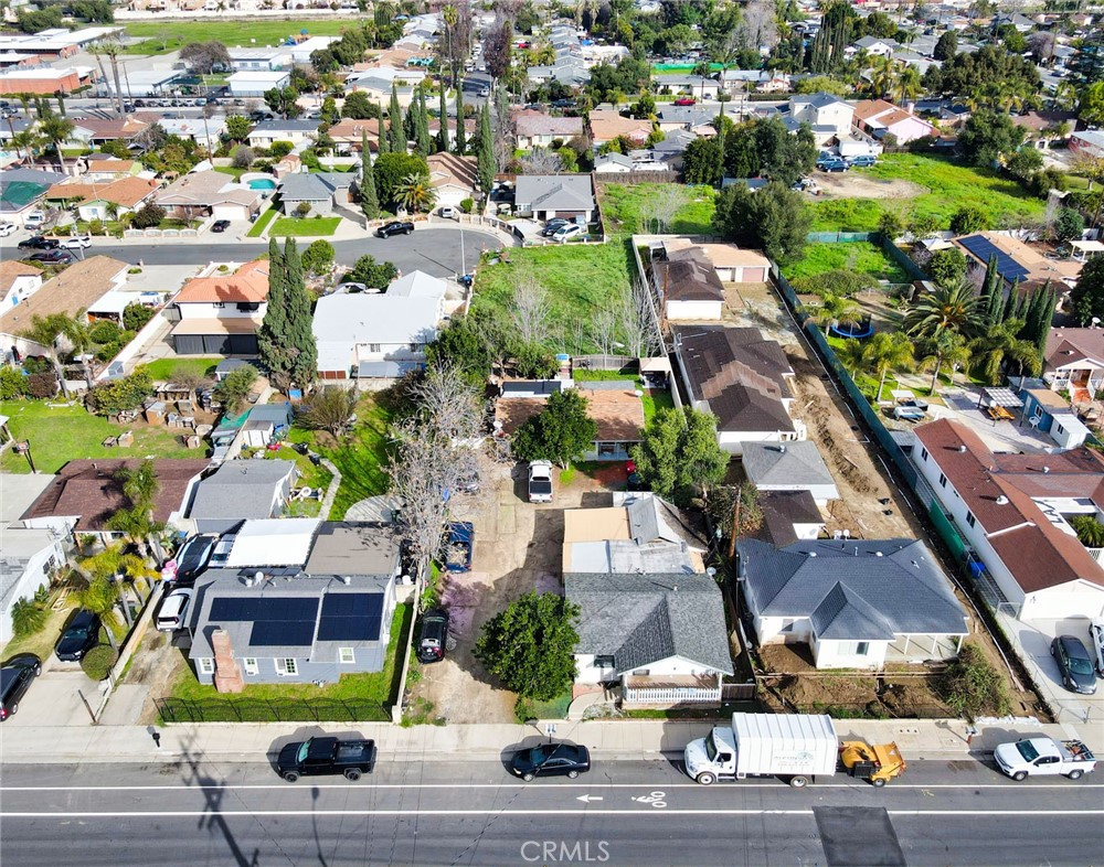 an aerial view of residential houses with yard