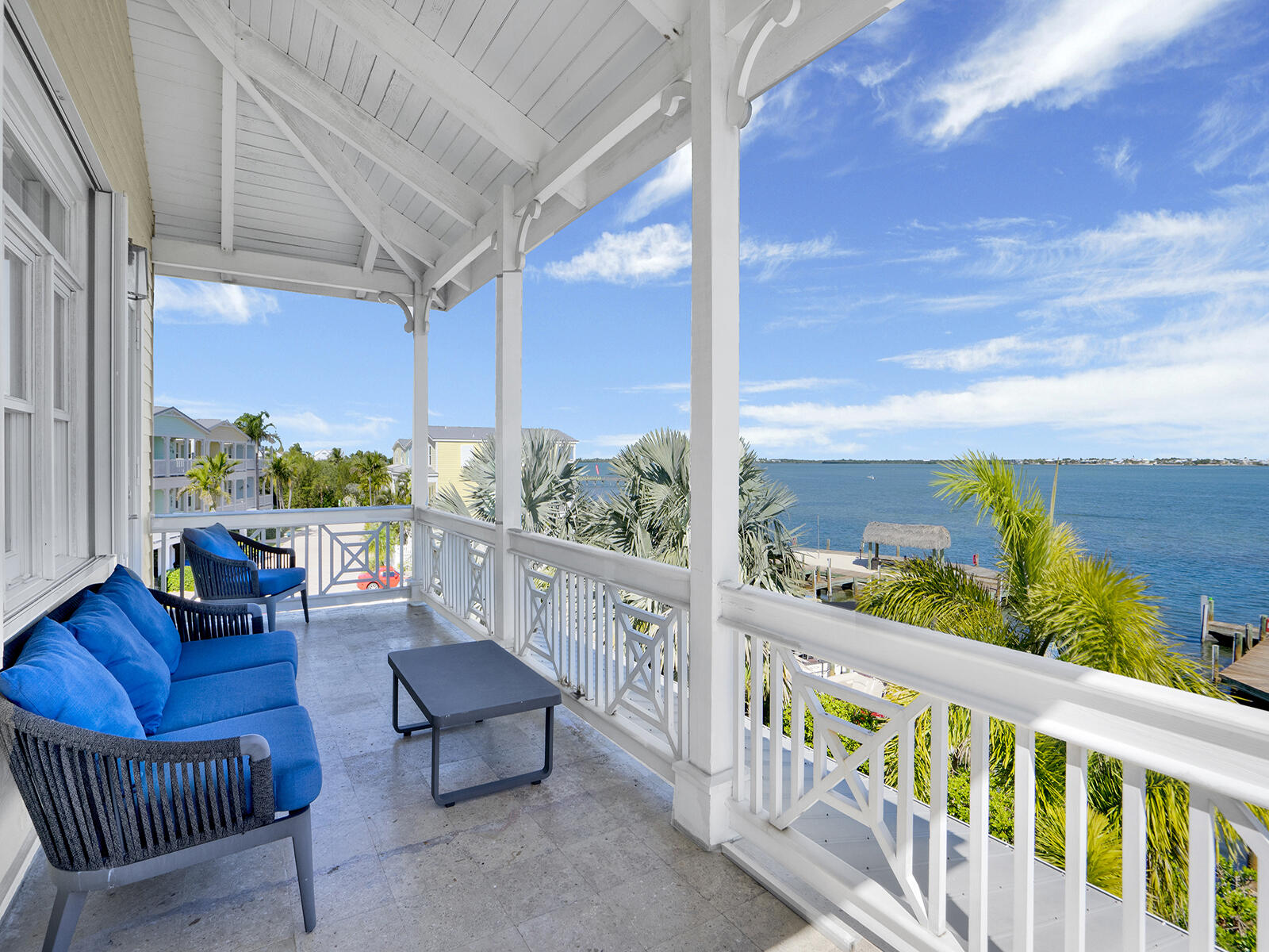 a balcony with furniture and a potted plant