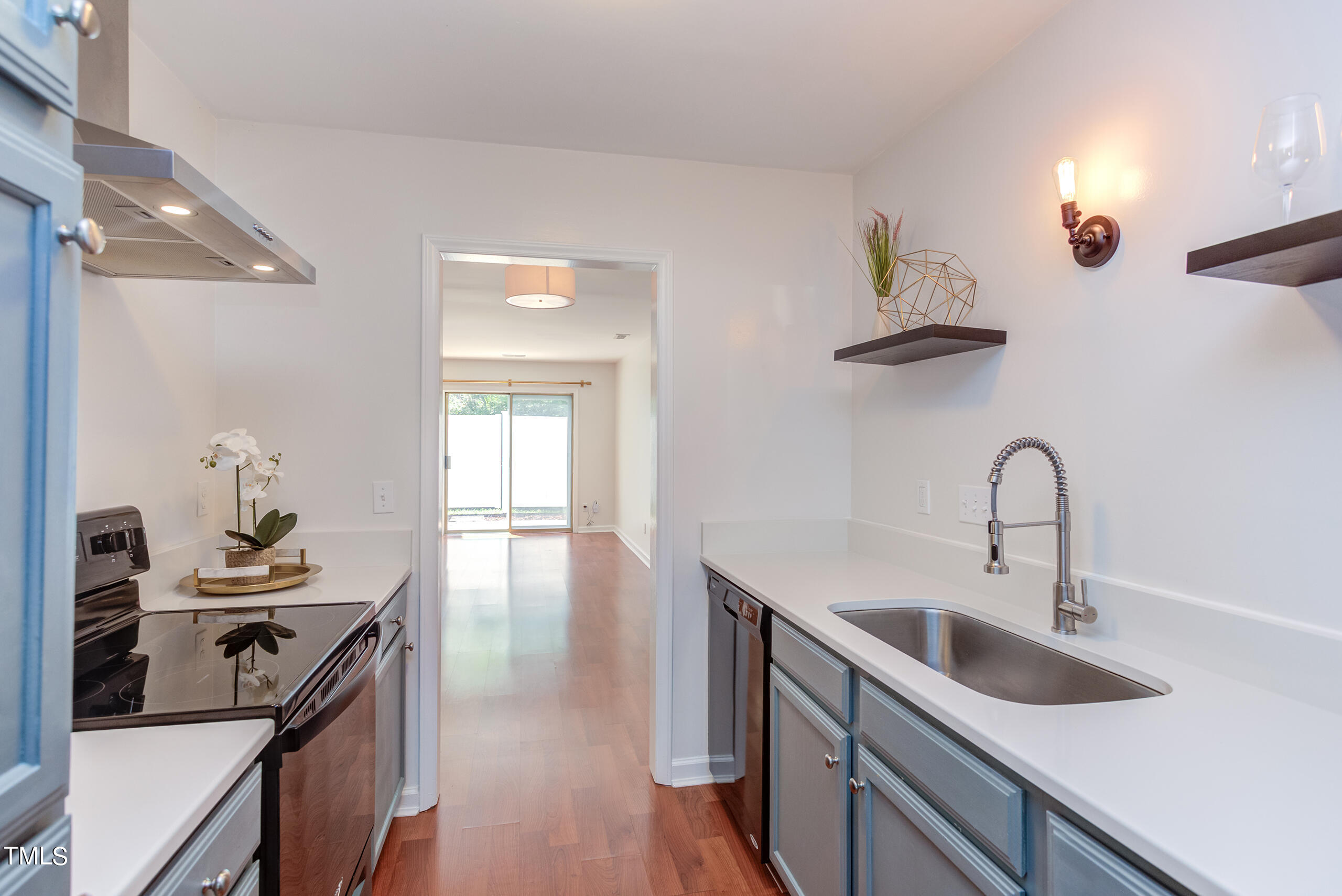 a kitchen with sink stove and cabinets