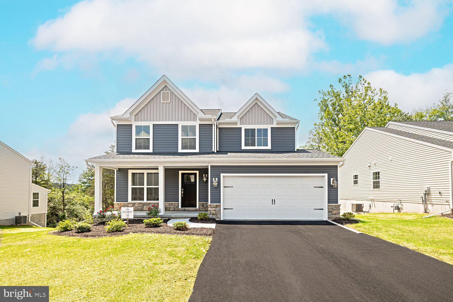 a front view of a house with a yard outdoor seating and garage