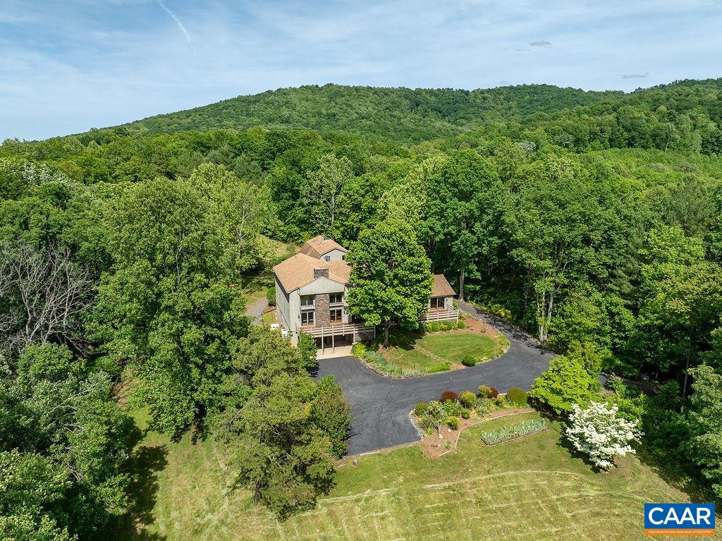 an aerial view of a house with a yard