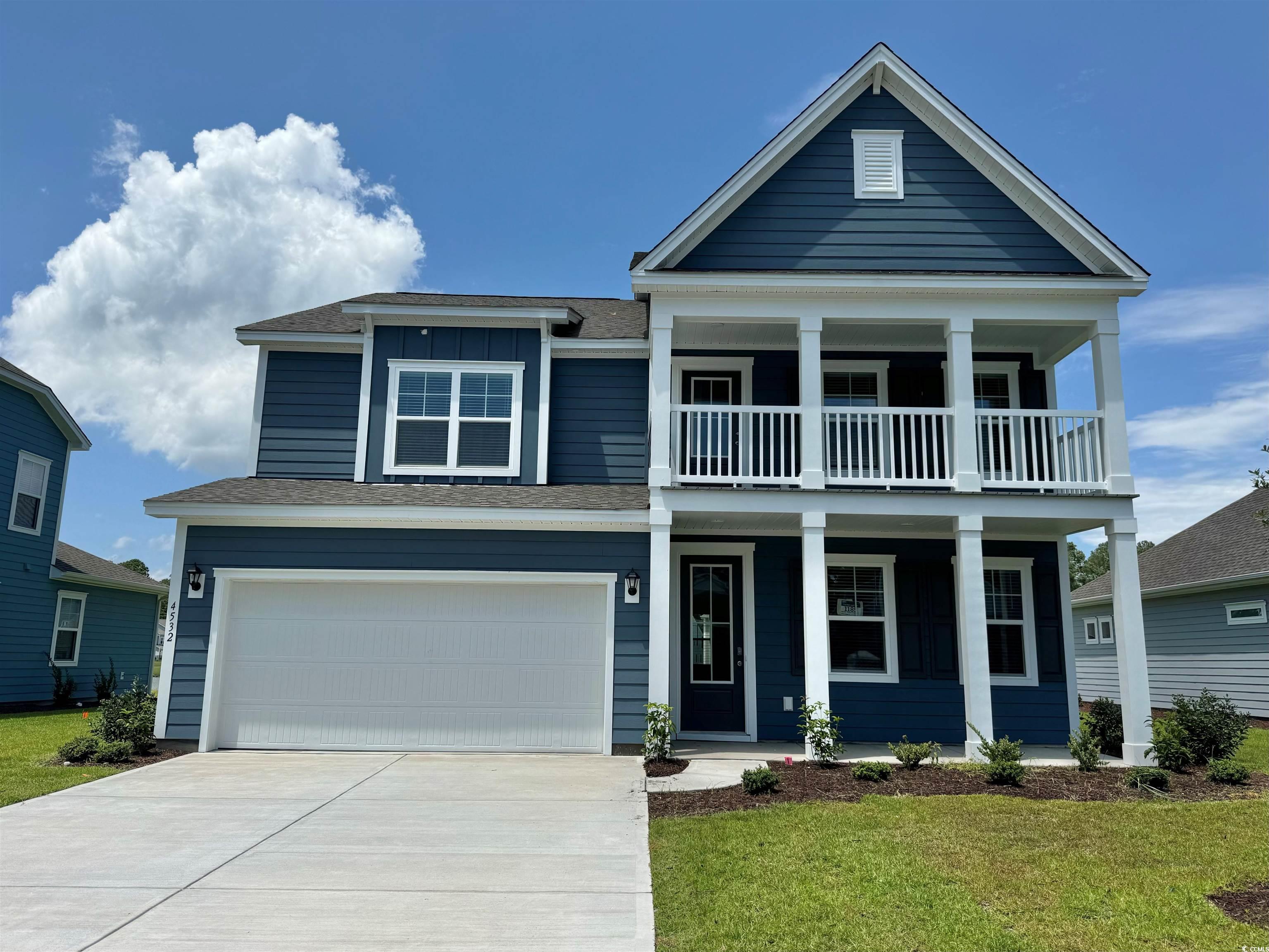 View of front of home featuring a garage, a balcon