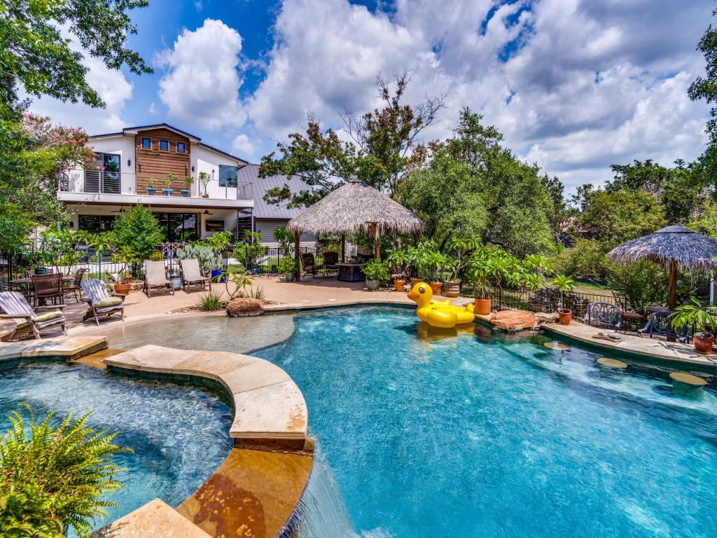 a swimming pool with outdoor seating and yard