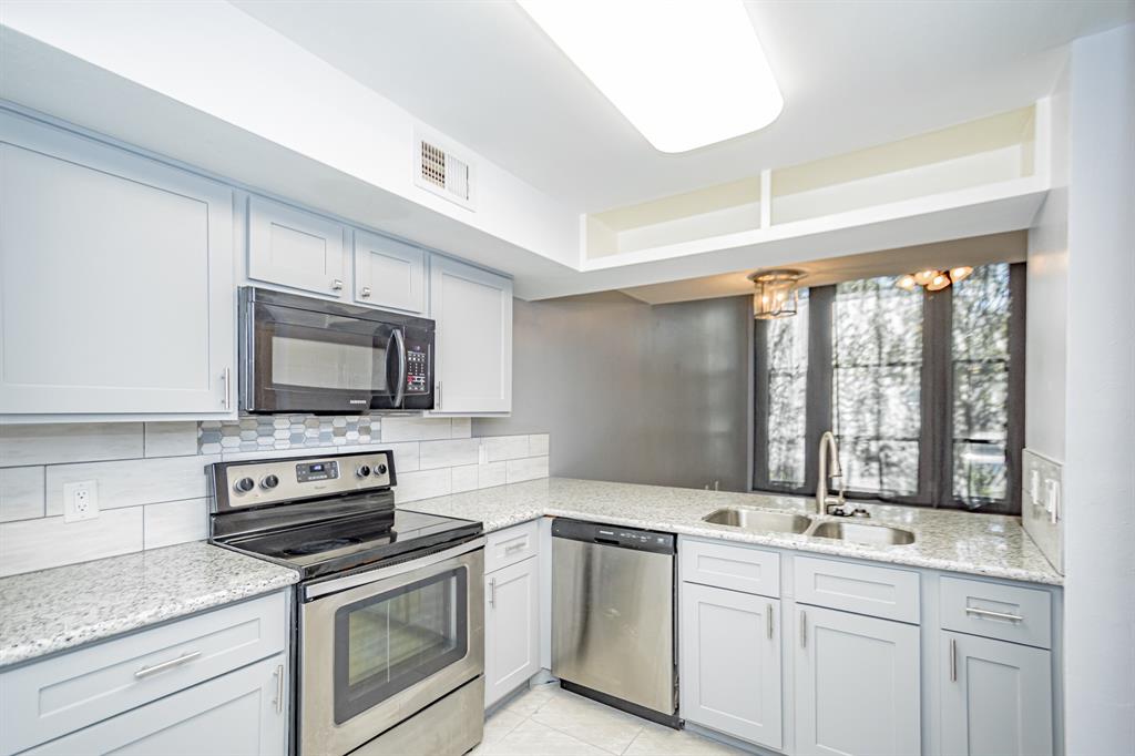 a kitchen with a stove and a sink