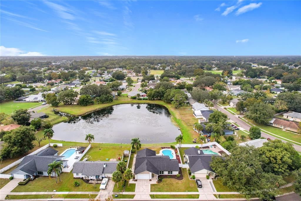 an aerial view of residential houses with outdoor space and swimming pool