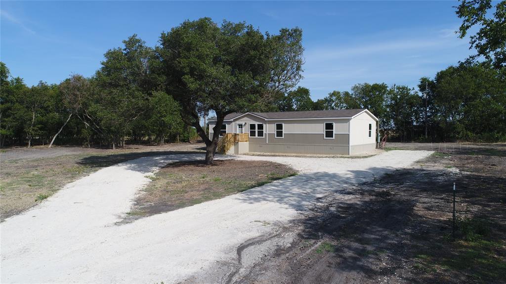 a view of a house with a backyard